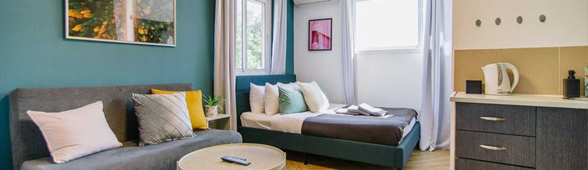 חדר בהוסטל בטא תל אביב, מיטה זוגית, מטבחון, ספה, שולחן